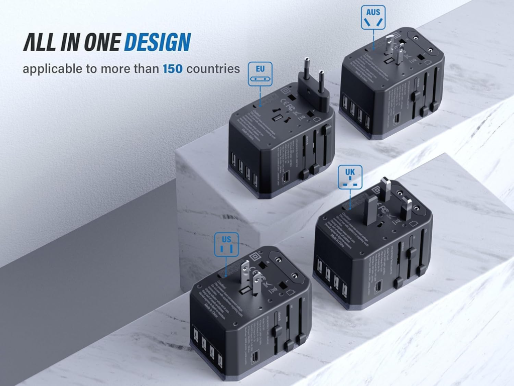 A pale blue universal travel adapter on a nightstand with a pen pointing to its safety fuse compartment and integrated USB ports. Universal all-in-one travel adapter with US, UK, EU, AUS plugs and multiple USB ports