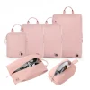 pink-nylon-compression-packing-cubes-set-1 Pink travel packing cube set with shoe and toiletry bags.